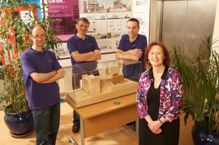 Manager and trustees with model of new building